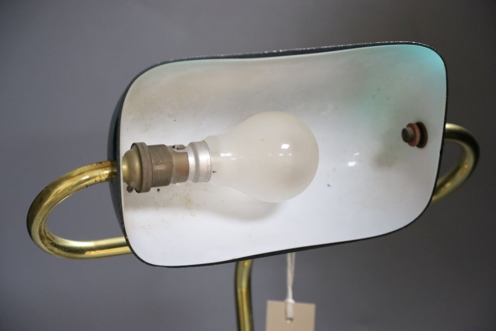 A brass desk lamp with green glass shade